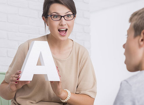ABA Therapy with Therapist showing letter